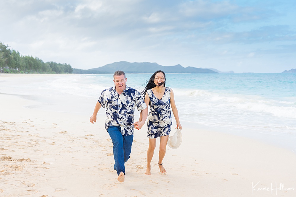 man and woman running on the beach 