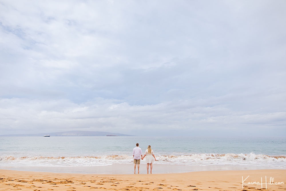 couple standing by the shore on Maui 