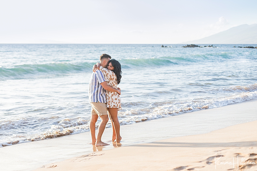 young couple in love embracing on hawaii beach 