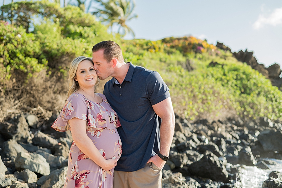 maternity photos with husband kissing wife on the beach 