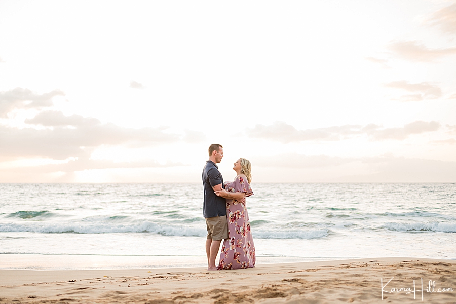 sunset photo of a husband and wife embracing in hawaii 