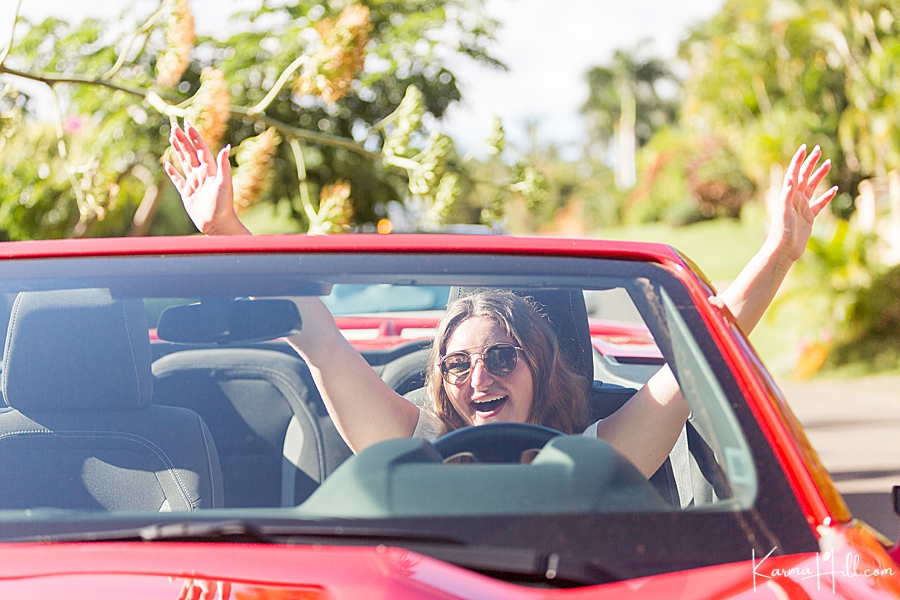teenager in red convertible in hawaii 