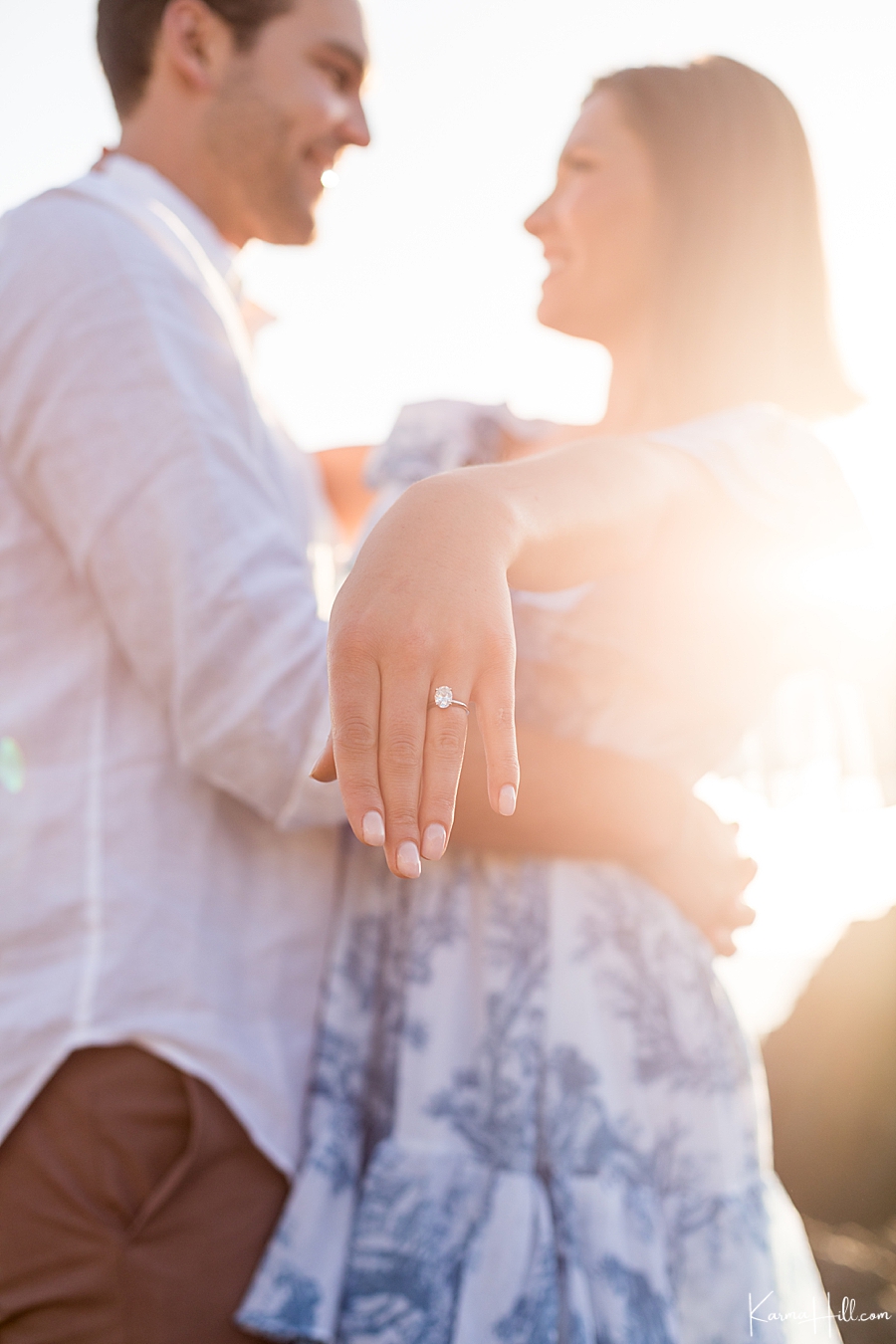 newly engaged couple show diamond engagement ring 