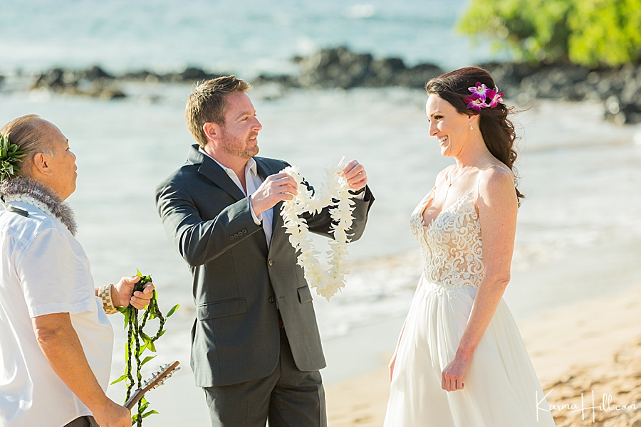 groom gives bride a lei 