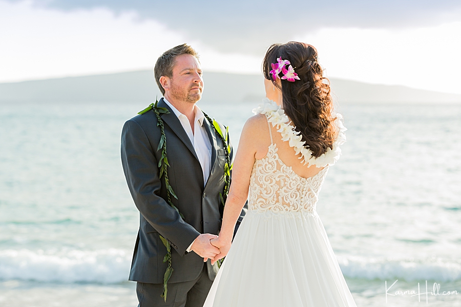 bride and groom look into each other's eyes while married on the beach in hawaii