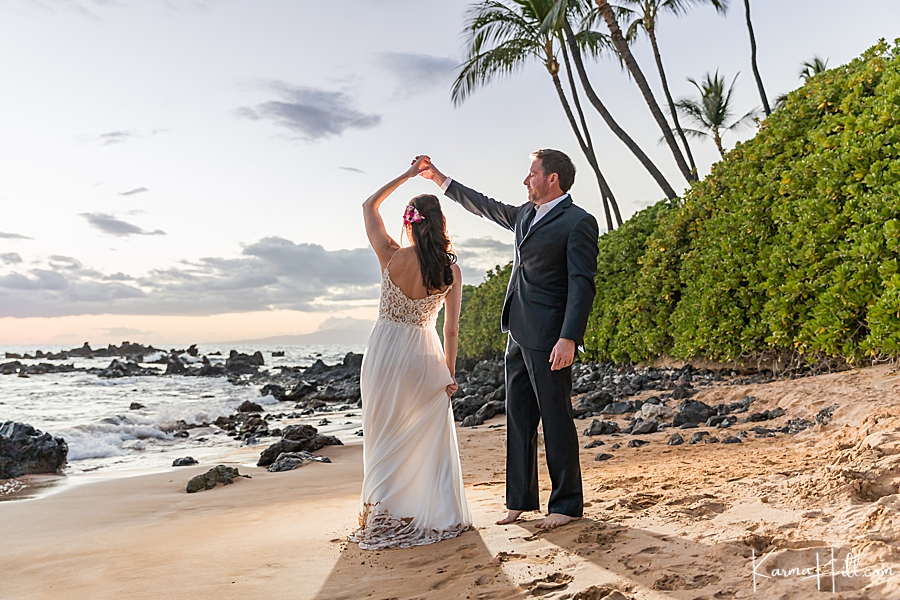 newly married couple dance on maui beach 
