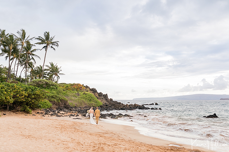long shot of a bride and groom on maui beach 