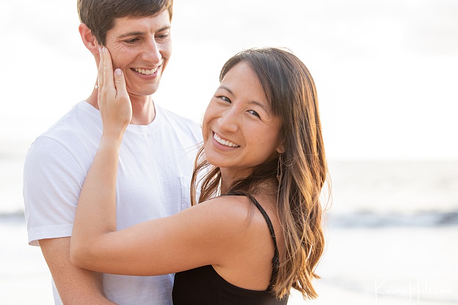 couple celebrate a recent proposal by the ocean in hawaii 