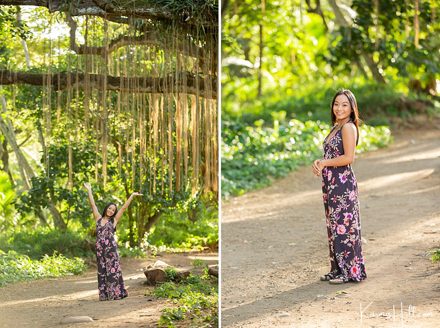 senior takes photos in a floral maxi dress in honolua jungle maui