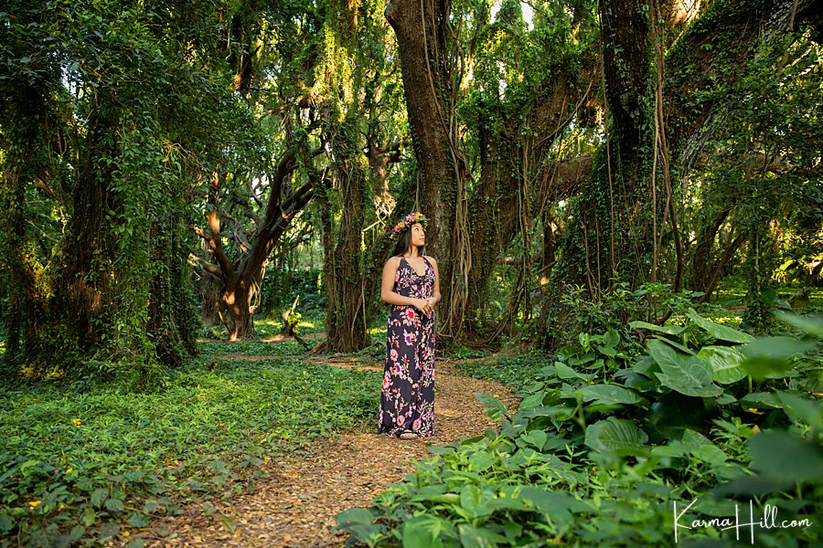 young woman in lei po'o in hawaiian jungle 