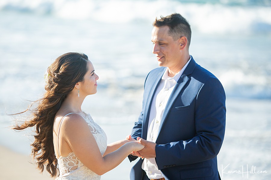 bride and groom exchange vows in front of the ocean 