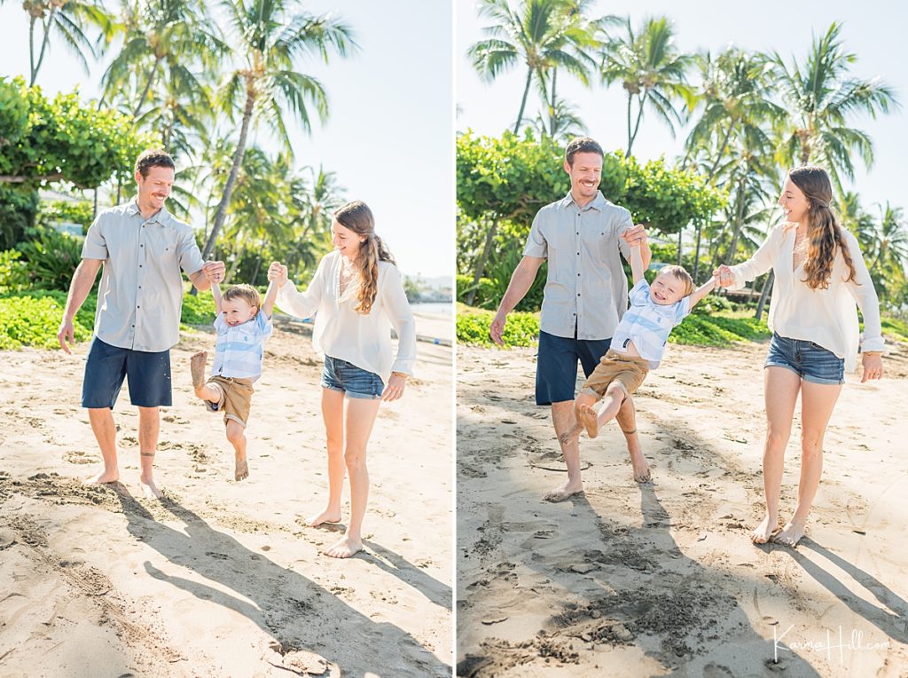 parents swing their young son on a beach in hawaii 