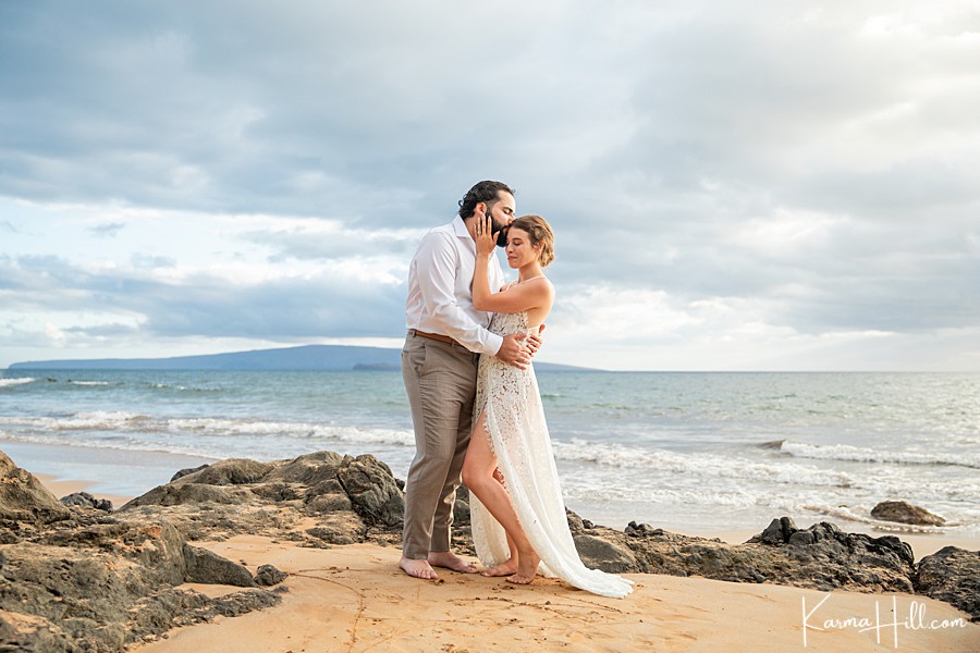 beautiful couple embrace on maui shore 