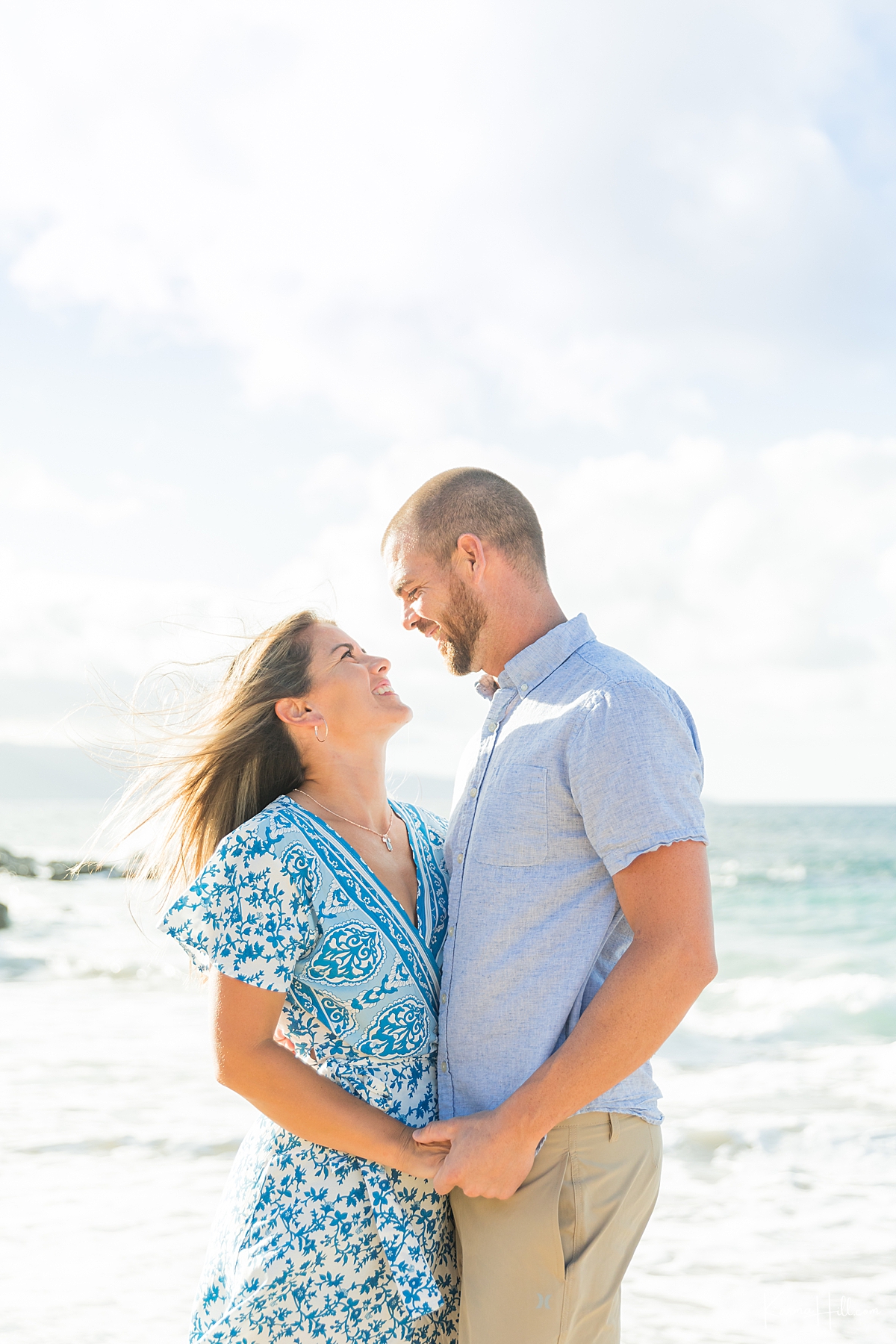 couple look lovingly into each other's eyes on a maui beach 