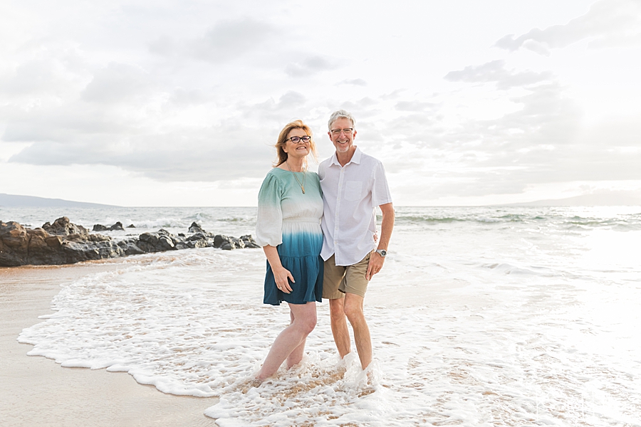 older couple stands on maui shore 