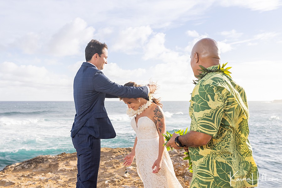 bride and groom exchange leis at kauai wedding