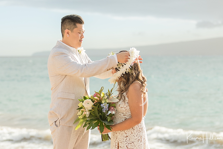 bride and groom exchange leis are maui ceremony