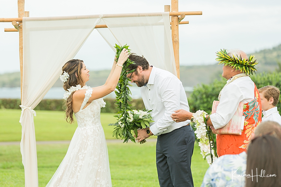 bride and groom exchange leis at maui wedding
