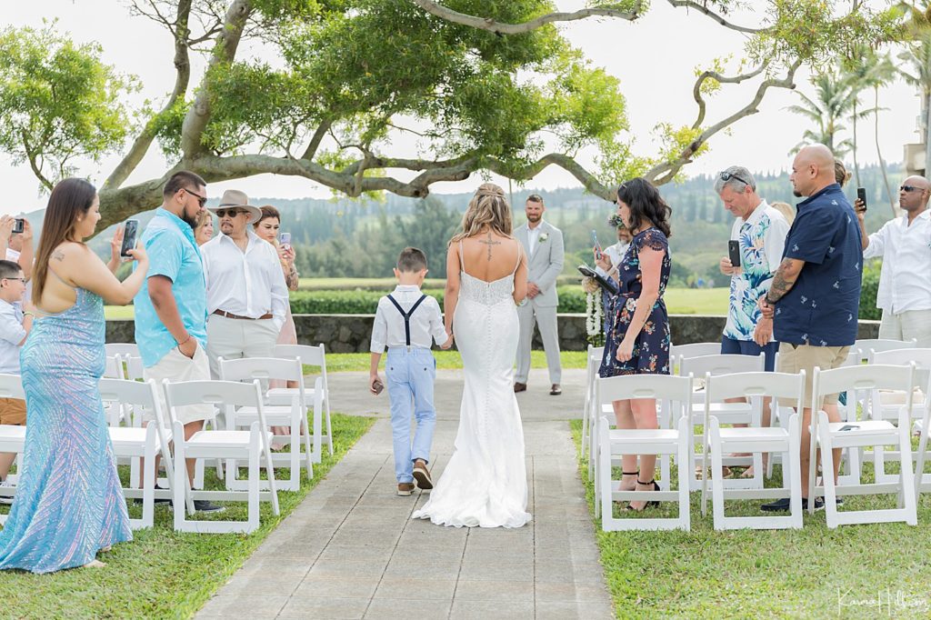 bride walking down the aisle with son