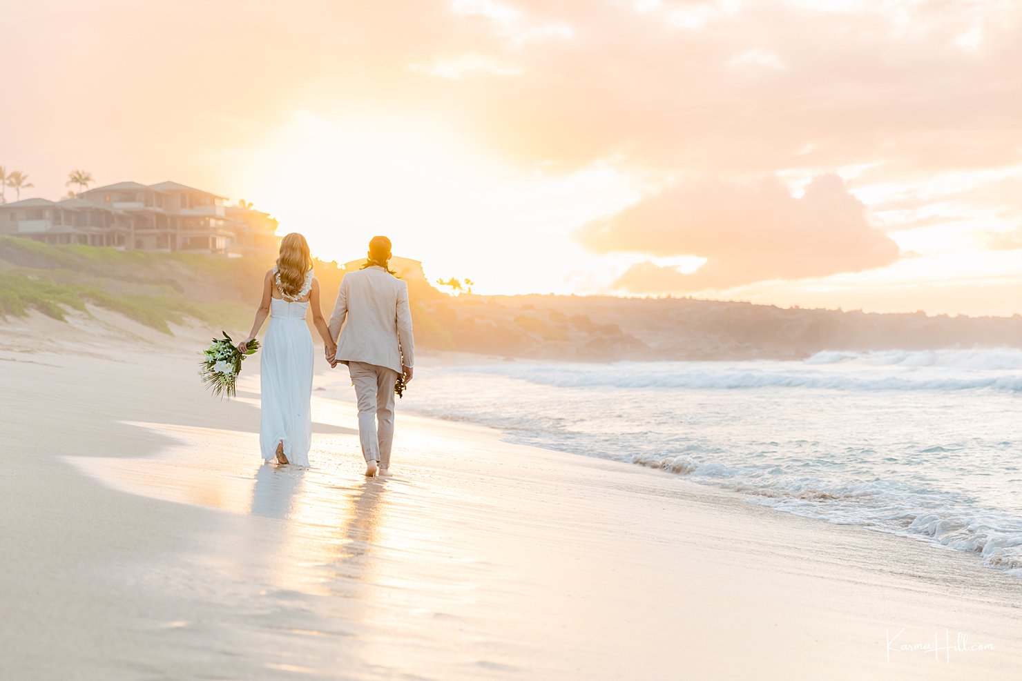 bride and groom walking into sunset in maui