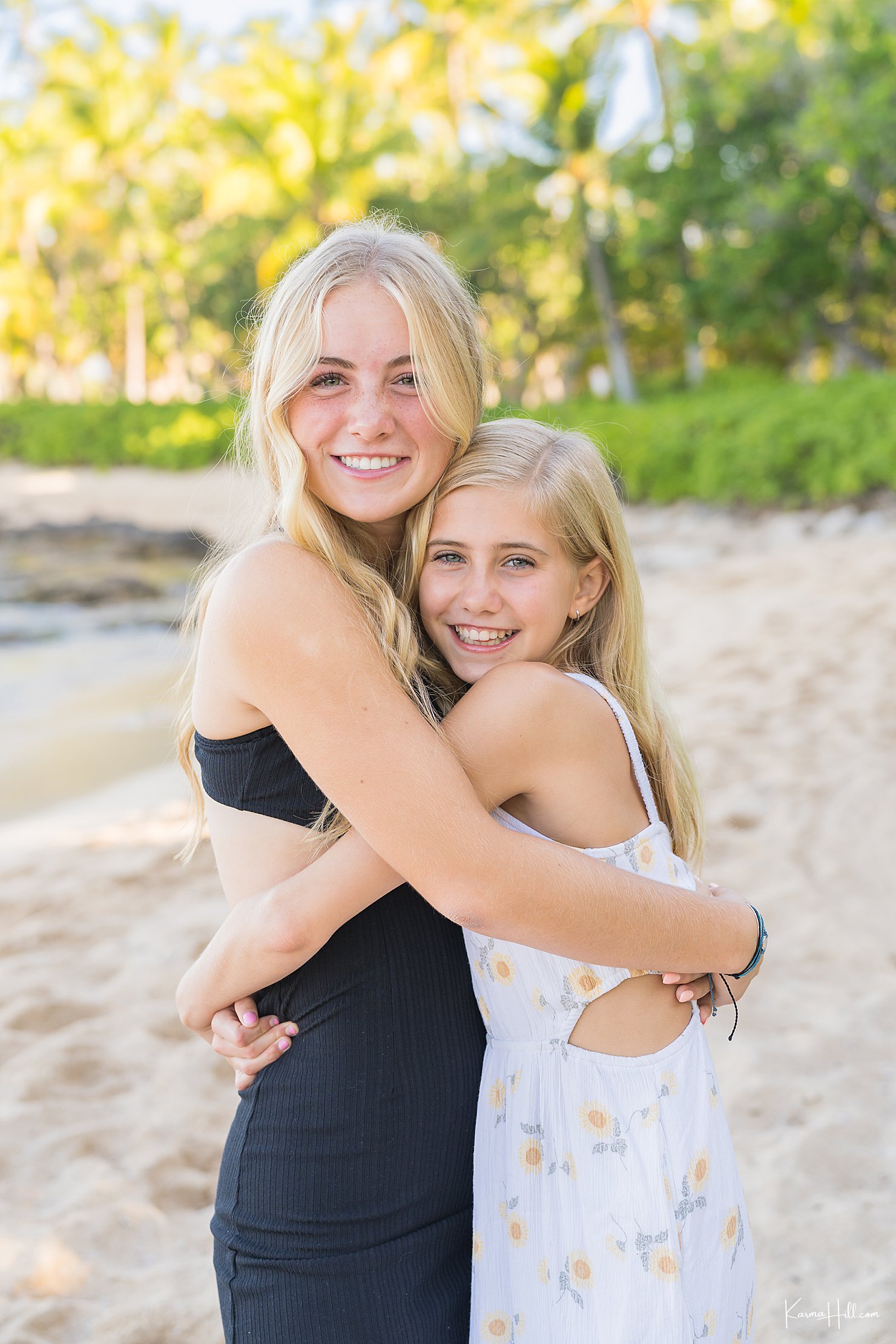 two daughters embracing on beach