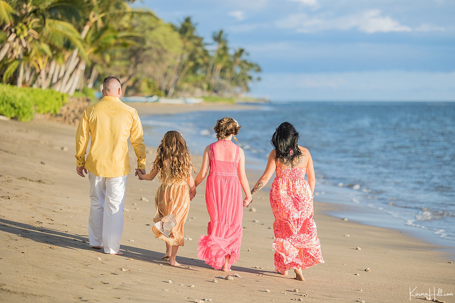 family walking on beach in maui