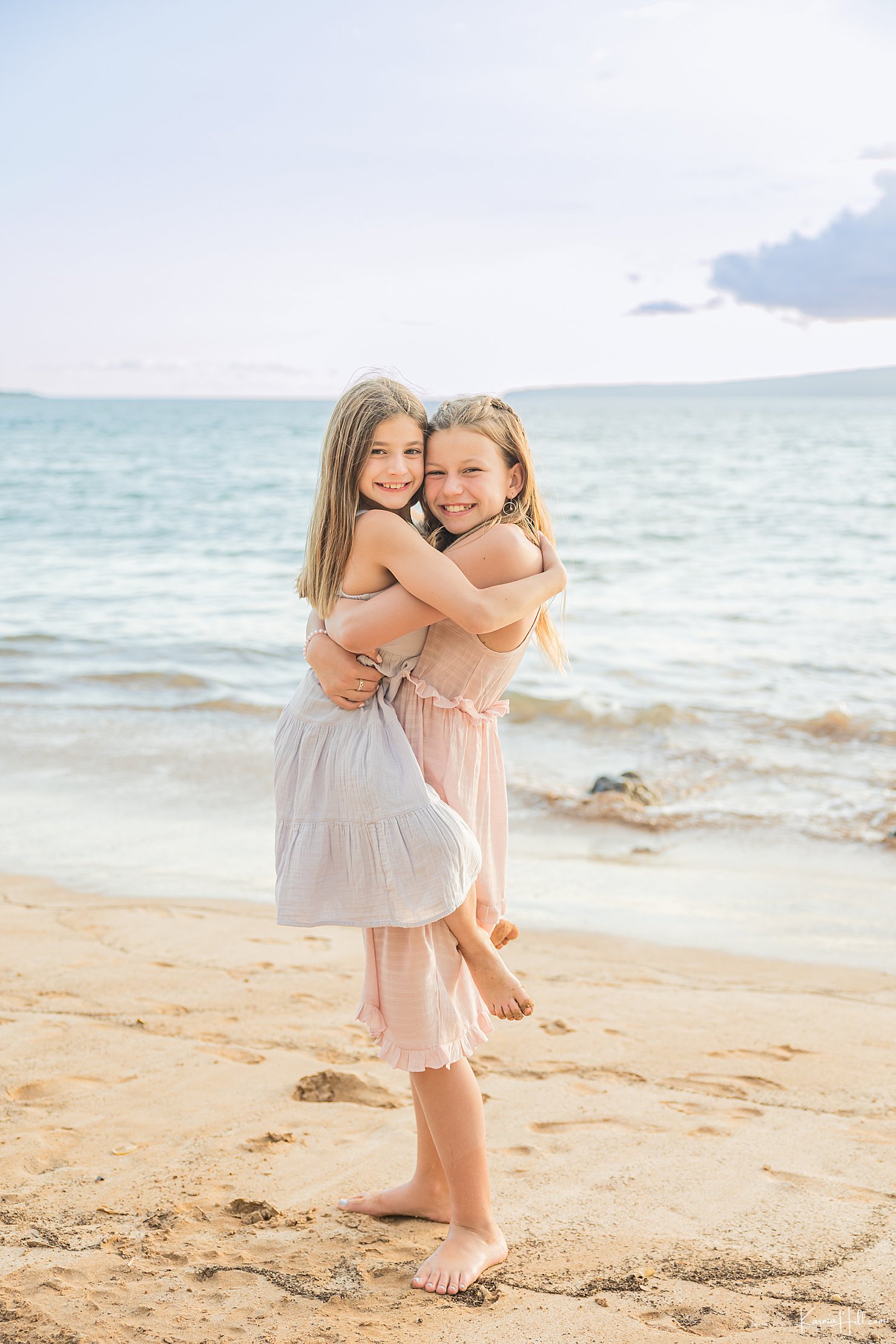 sisters hugging on beach