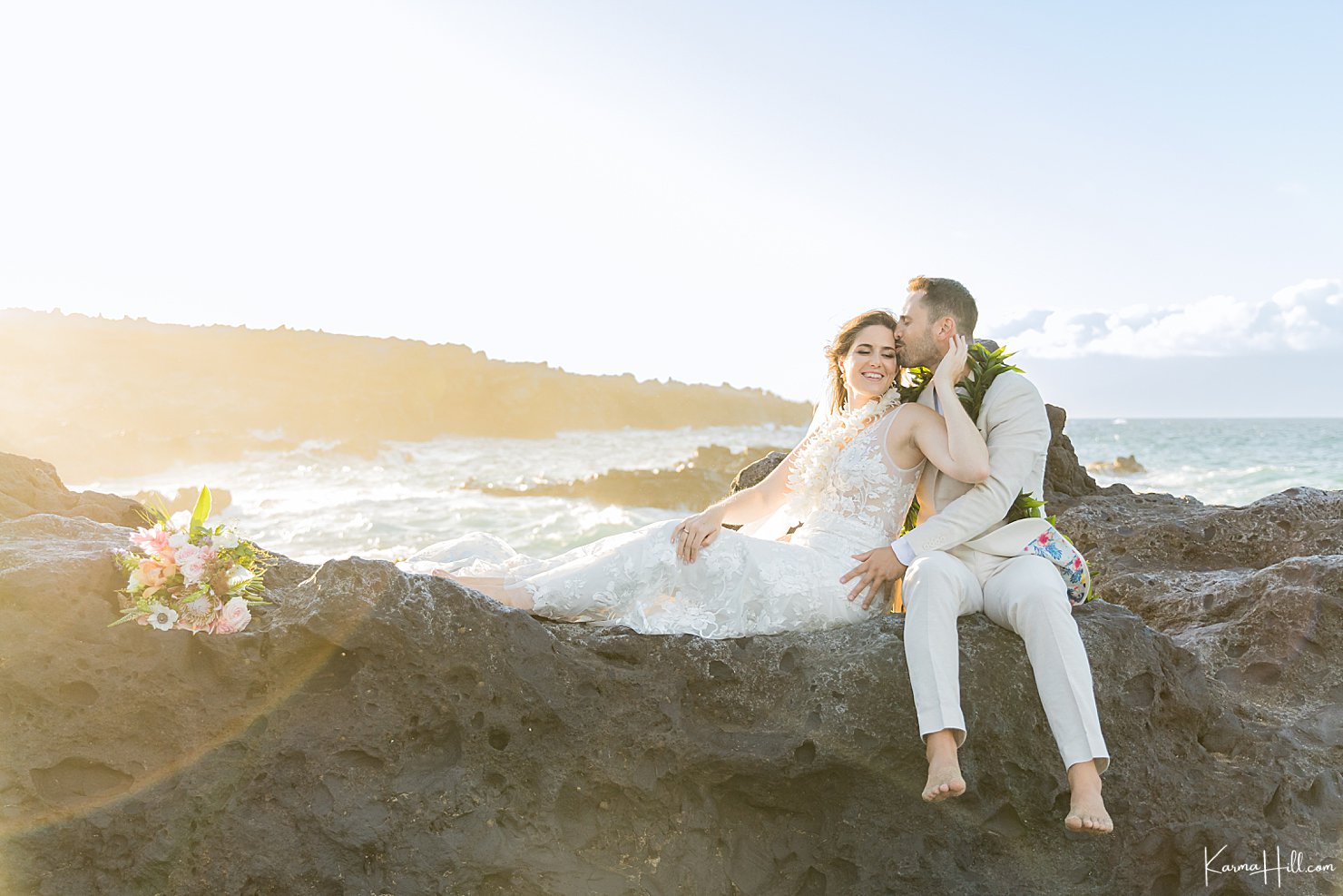 bride and groom on cliff in maui