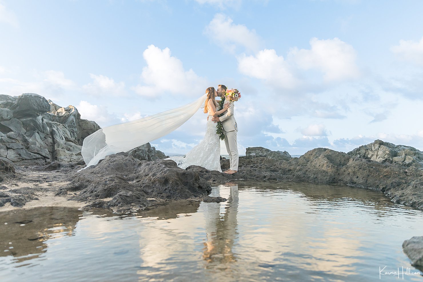 bride and groom by ocean