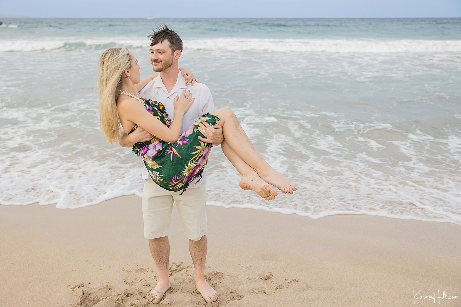 man holding girlfriend on beach