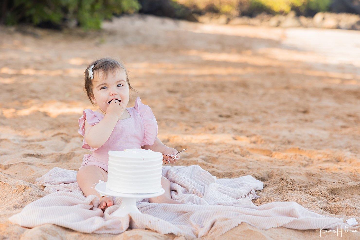 baby with cake on beach 